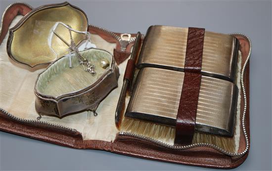 A gentlemens silver-mounted grooming set in leather case and a silver engine-turned shaped oval trinket box.